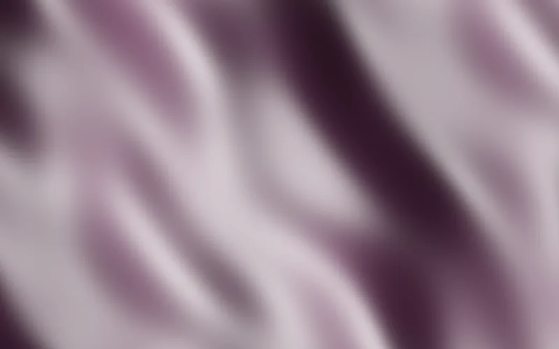 Silk shader preview: Heavy satin folding slowly, a long sheen running down each fold.